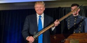 PHOTO Donald Trump Holding A Massive Gun Like It's A Toy