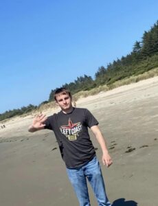 PHOTO Ethan Miller Waving At Camera While At The Beach