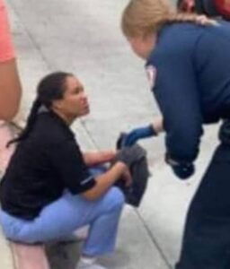 PHOTO Nicole Linton Sitting On Curb In Nurse Scrubs Talking To The EMT