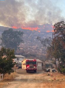 PHOTO Fire Trucks Setting Up Below Hill Shows How Close Fire Is To Burning Down Hundreds Of Homes In Hemet California
