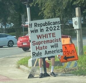 PHOTO Man On Colonial Drive In Orlando Florida Holding Sign That Says If Republicans Win In 2022 White Supremacist Hate Will Rule America