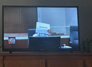 PHOTO Darrell Brooks Holding Up Piece Of Paper That Says Objection While Hiding Behind It