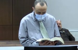 PHOTO Darrell Brooks Pretending To Read Bible To Ignore Judge During Trial