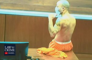 PHOTO Darrell Brooks Sitting Ontop Of Courtroom Table Shirtless Like He's In Charge Of Something