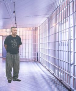 PHOTO Paul Flores Standing In His Pajamas Looking At The Jail Cell That Is His New Home