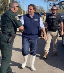 PHOTO Ted Cruz Picked Out Ron DeSantis' Storm Clothes So DeSantis Looked Like An Elf With High Socks As He Surveyed Hurricane Ian Damage