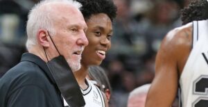 PHOTO Gregg Popovich Smiling And Putting His Arm Around Josh Primo While Coaching Him