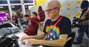 PHOTO Grant Wahl Sitting At His Computer Inside World Cup Game In Qatar Wearing Rainbow T-Shirt