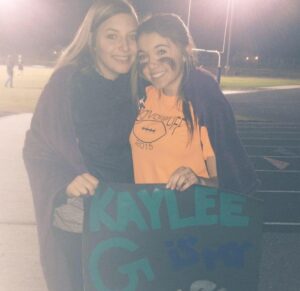 PHOTO Kaylee Goncalves Holding Powder Puff Football Sign At High School Football Game