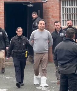 PHOTO Brian Walshe Being Led Out Of Home In Handcuffs With Bags On His Feet After Authorities Took His Shoes To Preserve As Evidence