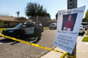 PHOTO In Loving Memory Of Bishop O'Connell Sign On Tree Outside His House In California