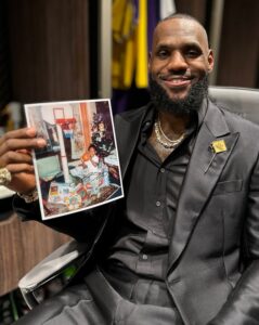 PHOTO Lebron Holding Up A Picture Of Him Shooting On A Hoop At 3 Years Old In The Locker Room After Passing Kareem