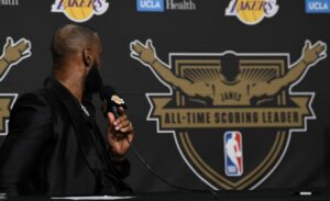 PHOTO Lebron Looking At All-Time Scoring Leader Logo With His Last Name On The Back While At The Podium