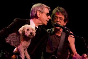 PHOTO Richard Belzer Holding A Dog