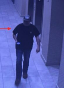 PHOTO Of Nathan Millard Walking Around Hallway With Phone In His Hand