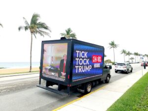 PHOTO Truck With Tick Tock Trump And Hillary Clinton Peaking Into Donald Trump's Jail Cell Circling Mar-A-Lago