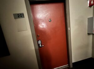 PHOTO Of Where Police Lind Up Outside Nima Momeni's Door In The Besler Building in Emeryville California For Murder Of His Friend
