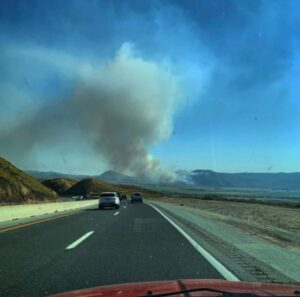 PHOTO Ramona Fire Can Be Seen Burning On The Side Of The Road On The Freeway In San Jacinto California