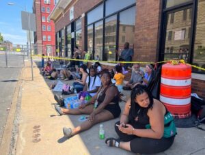 PHOTO Family Members Of Missing Tenants In Davenport Apartment Collapse Sitting Outside City Hall With No Support