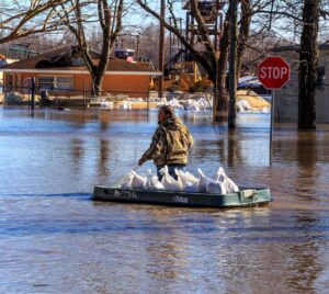 PHOTO Dude With Sand Bags Boating Through Heavy Water In West Point NY