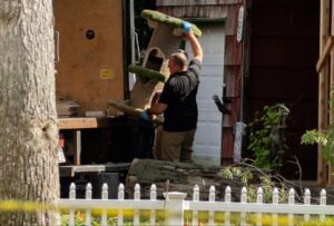 PHOTO Law Enforcement Carrying Sugar-Free Cough Drops Gumball Machine And Cat Tower From Rex Heuermann's House