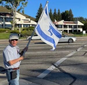 PHOTO Paul Kessler Holding Israeli Flag In The Street