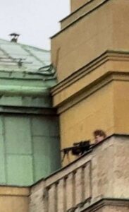 PHOTO Close Up Of David Kozac Firing Automatic Gun From Balcony In Prague