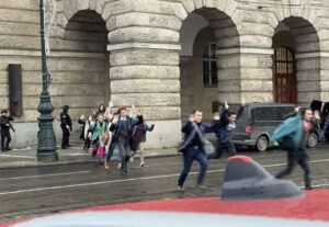 PHOTO People Running Out Of Prague’s Charles University With Hands Up