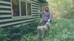 PHOTO E Jean Carroll Walking Her Dog In The Forest Near Her House While Wearing Red Wig