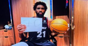 PHOTO Joel Embiid Holding A Piece Of Paper With 70 On It