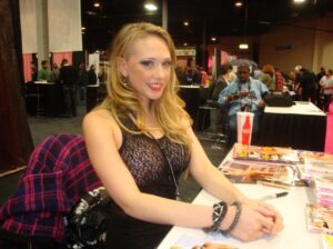 PHOTO Kagney Linn Karter Trying To Look Happy Signing Autographs At A Table