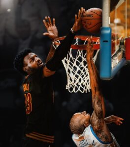 PHOTO Bronny James In A Cleveland Cavaliers Uniform Blocking Andre Iguodala In The NBA Finals