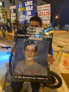 PHOTO Demonstrators Outside RNC Holding A Sign That Says RIP Thomas Crooks