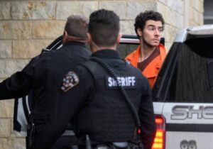 PHOTO Luigi Mangione Staring Down Reporters While Wearing Orange Prison Uniform