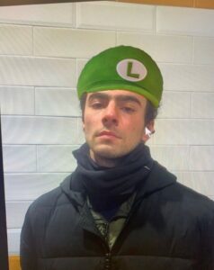 PHOTO Luigi Mangione Wearinh Green Luigi Hat From Mario Cart Meme