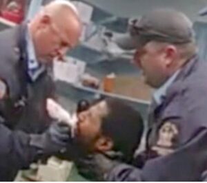 PHOTO Of Prison Guards Hand On Robert Brooks' Throat