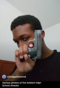 PHOTO Solomon Henderson Pointing Handgun At Ceiling In His Bedroom Like A Psycho