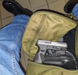 PHOTO Solomon Henderson Showing Off Handgun He Had Hidden In Bag