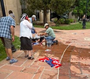 PHOTO Of Woman On The Ground After Being Firebombed
