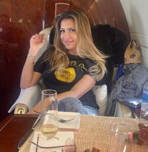 PHOTO Jasveen Sangha Wearing Shirt With Coin On It While On Private Jet