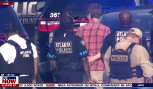 PHOTO Police Taking Man Into Custody Wearing Red Dress Shirt At Emery University Shooting Scene