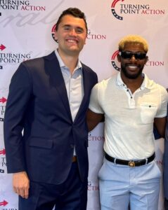 PHOTO Charlie Kirk Posing For A Picture With Xaviaer DuRousseau