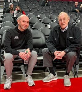 PHOTO Rick Adelman Sitting Next To David Adelman On The Nuggets Bench